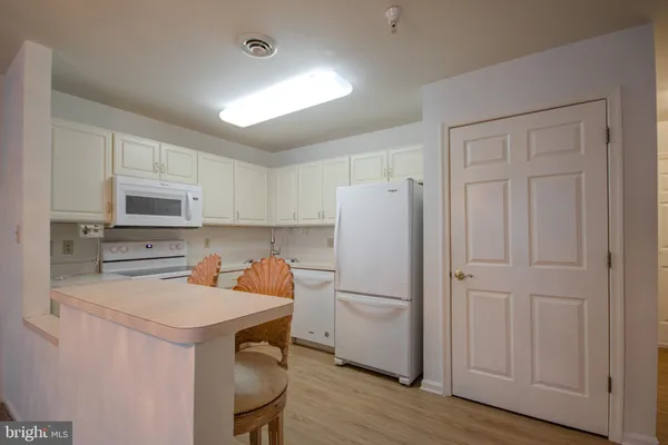 a kitchen with a sink appliances and cabinets