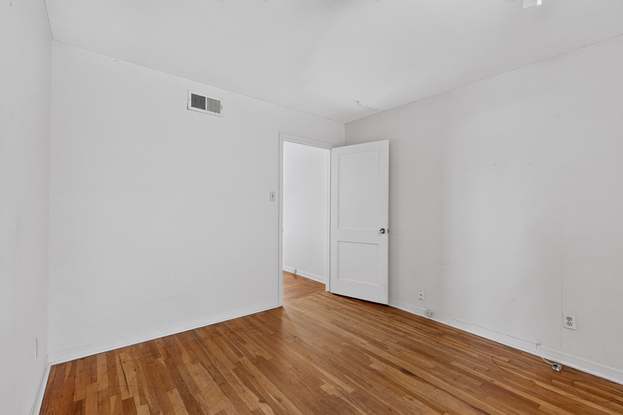 4703 Leslie Avenue Austin, TX 78721 - Photo 17 of 34 Naturally illuminated room boasting a classic hardwood floor.