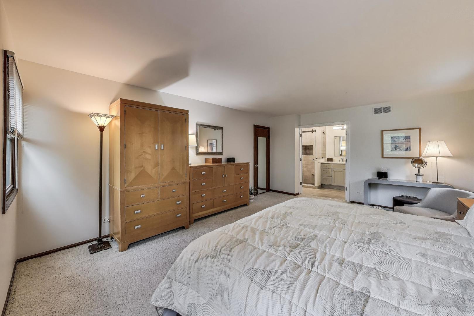 645 Ridge Road Highland Park, IL 60035 - Photo 16 of 32 a large bedroom with a bed and large windows