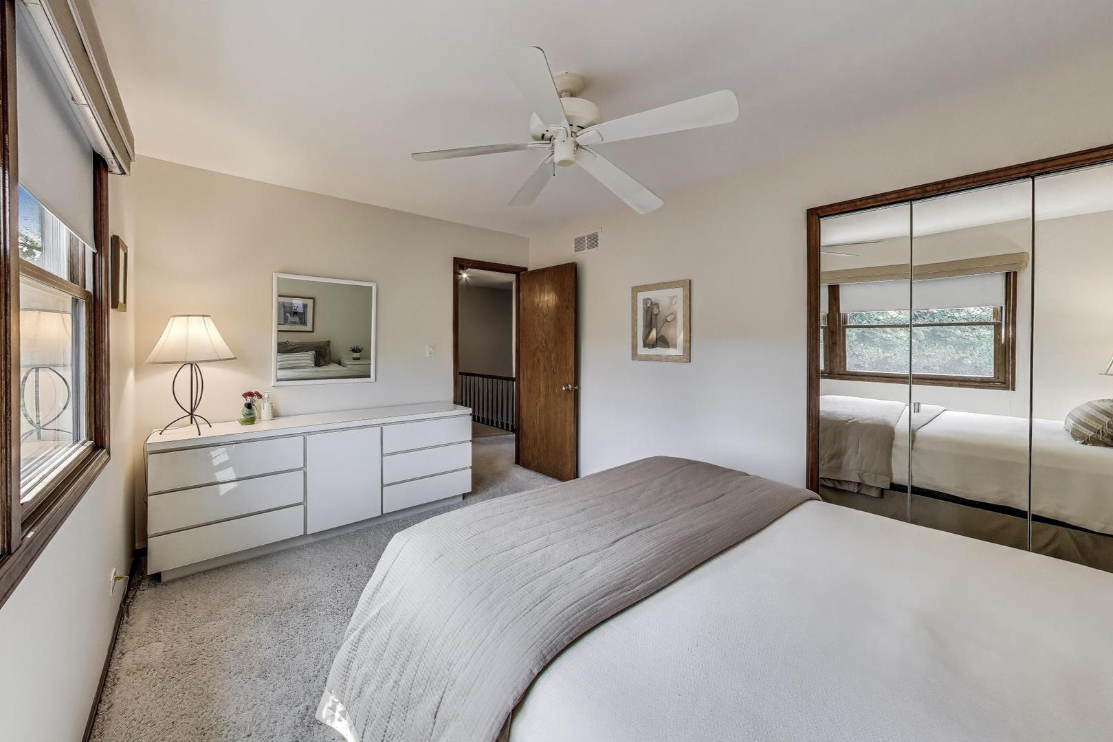 645 Ridge Road Highland Park, IL 60035 - Photo 18 of 32 a bedroom with a bed and a chandelier