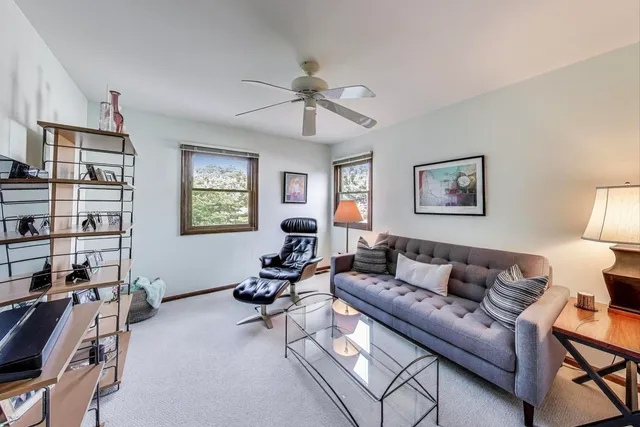 a living room with furniture a rug and a window