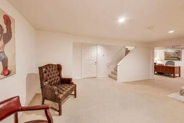 a living room with furniture and a chair