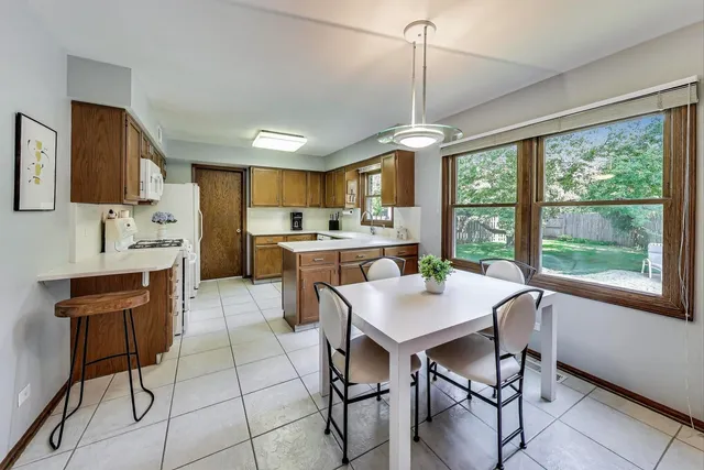 a dining room with furniture a chandelier and window