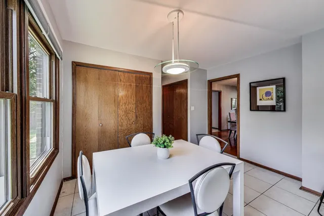 a view of a dining room with furniture and a chandelier