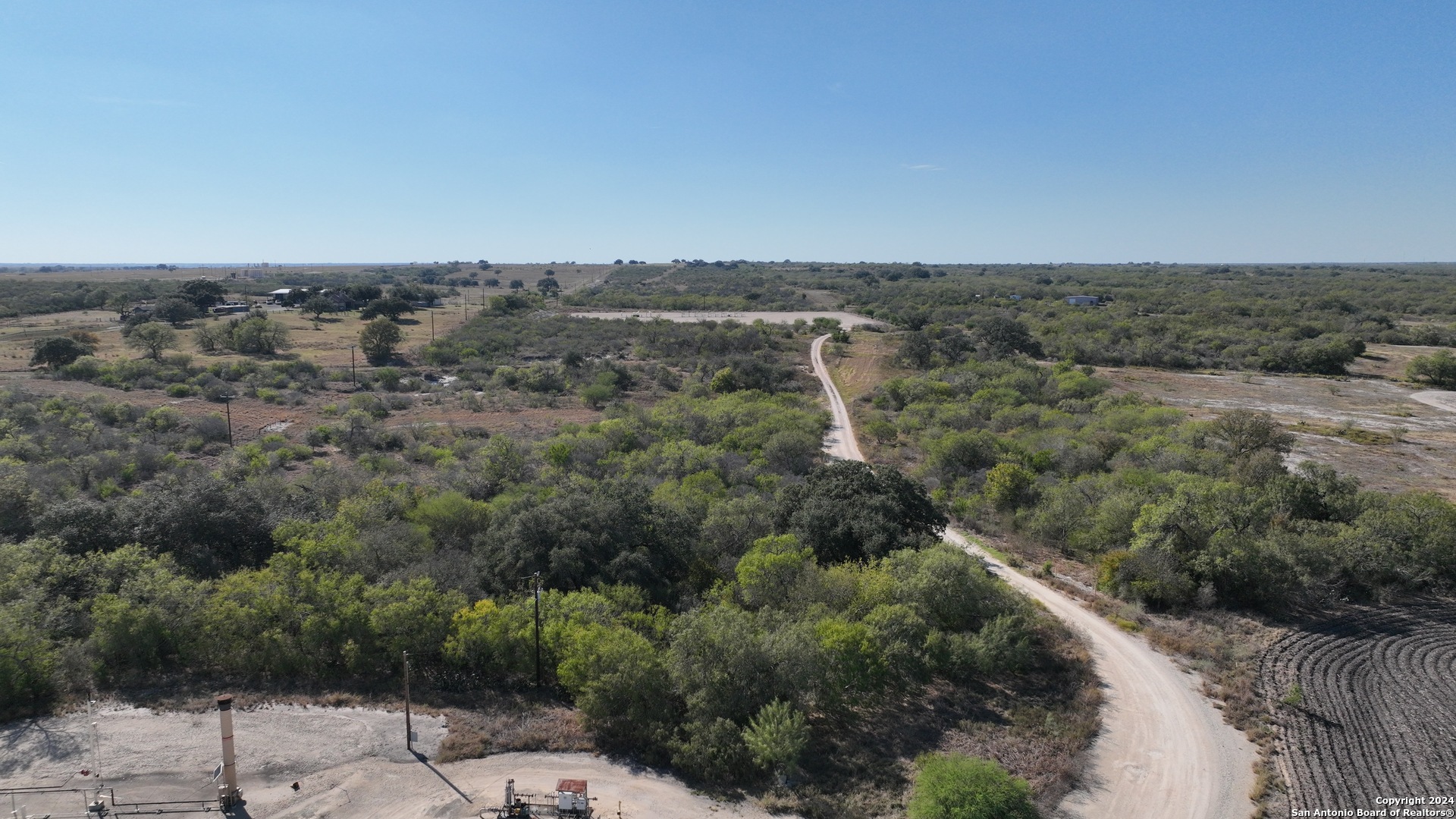 171-acres Highway 80 Gillett, TX 78116 - Photo 1 of 12 an aerial view of a house with a yard