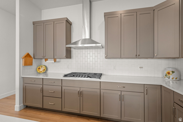 531 North Legend Way West, Unit D Mapleton, UT 84664 - Photo 12 of 42 Kitchen with gray cabinets, light wood-type flooring, tasteful backsplash, stainless steel gas stovetop, and light stone countertops