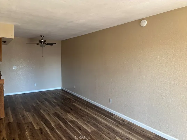 a view of a room with wooden floor