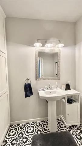 a bathroom with a toilet a sink and a mirror
