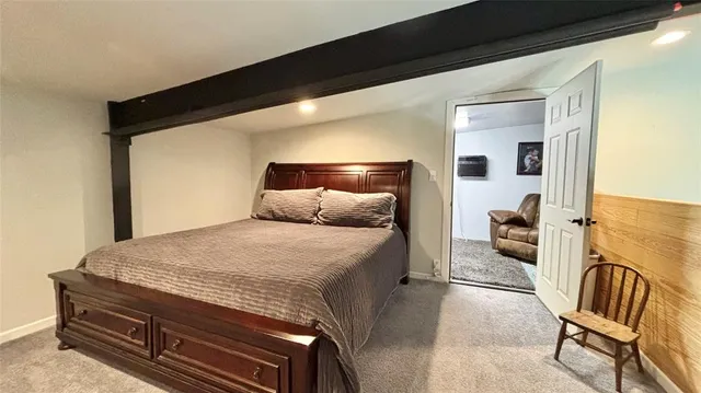 a spacious bedroom with a bed and couch