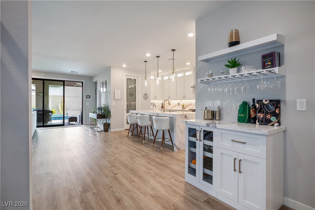 3018 Bounding Home Road North Las Vegas, NV 89086 - Photo 11 of 43 Bar area with white cabinets, hanging light fixtures, open shelves, recessed lighting, and light wood-type flooring