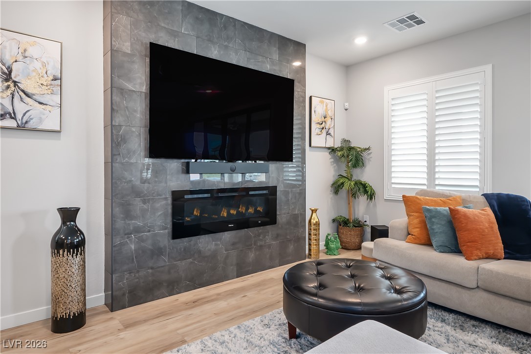 3018 Bounding Home Road North Las Vegas, NV 89086 - Photo 14 of 43 Living room featuring wood finished floors and a tile fireplace