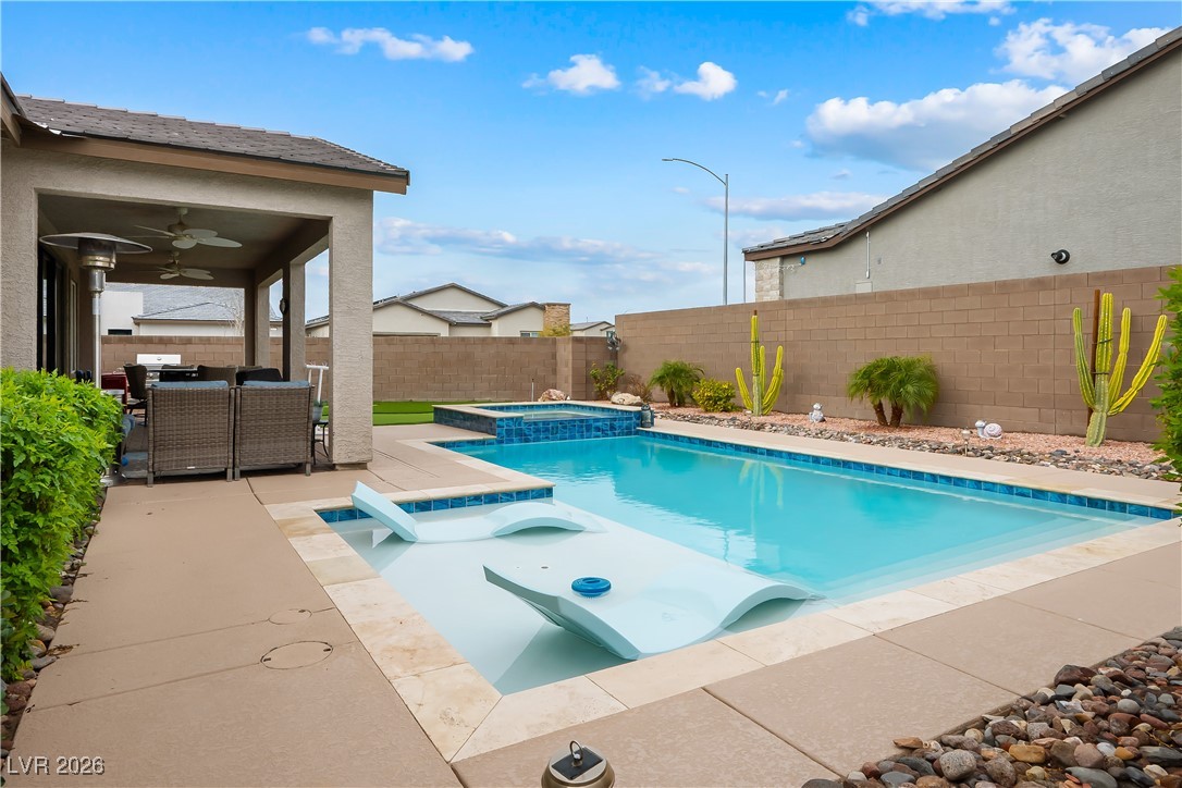 3018 Bounding Home Road North Las Vegas, NV 89086 - Photo 2 of 43 View of swimming pool featuring a patio area, outdoor dining space, a fenced backyard, and a pool with connected hot tub