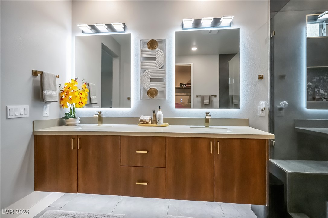 3018 Bounding Home Road North Las Vegas, NV 89086 - Photo 23 of 43 Bathroom with double vanity, a shower stall, and light tile patterned flooring
