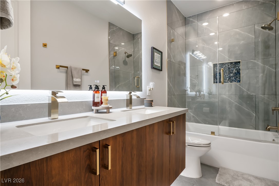 3018 Bounding Home Road North Las Vegas, NV 89086 - Photo 29 of 43 Full bath featuring double vanity and shower / bath combination with glass door