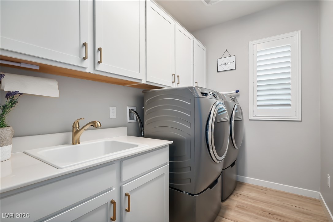 3018 Bounding Home Road North Las Vegas, NV 89086 - Photo 31 of 43 Laundry room with cabinet space, washer and dryer, and light wood-style floors