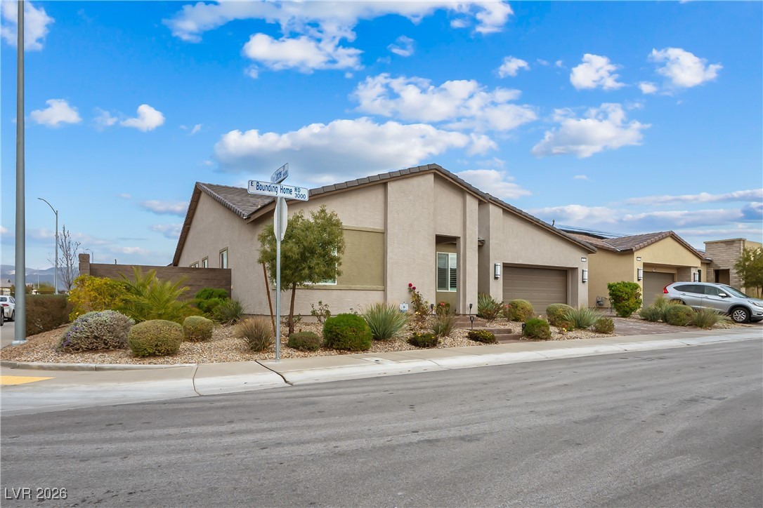 3018 Bounding Home Road North Las Vegas, NV 89086 - Photo 37 of 43 View of side of home with stucco siding and a garage
