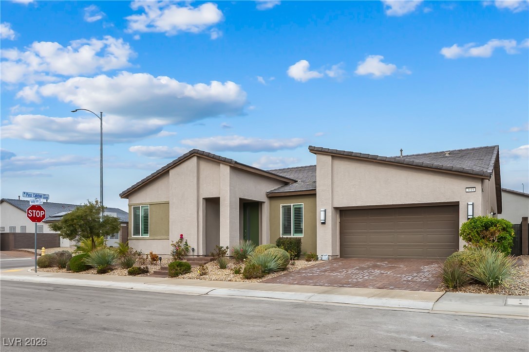 3018 Bounding Home Road North Las Vegas, NV 89086 - Photo 39 of 43 View of front of home with stucco siding, decorative driveway, and a garage