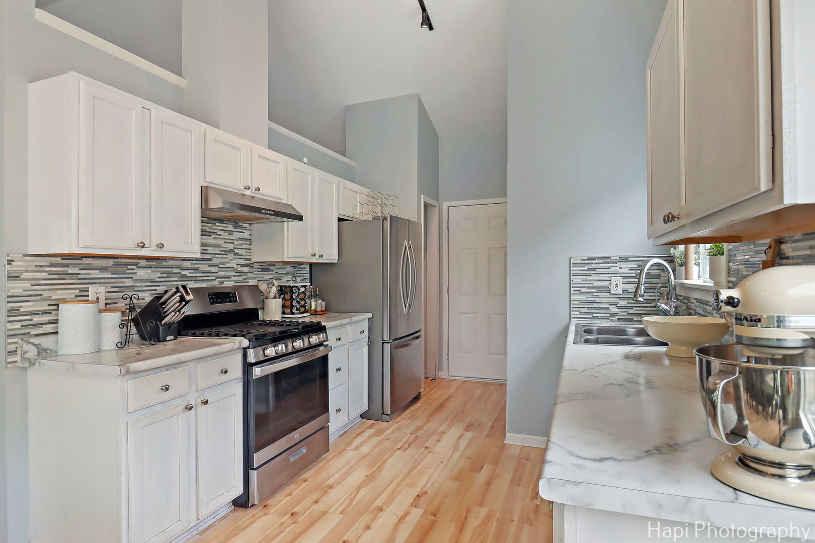 1504 9th Street Harvard, IL 60033 - Photo 6 of 24 a kitchen with a stove a sink and a refrigerator