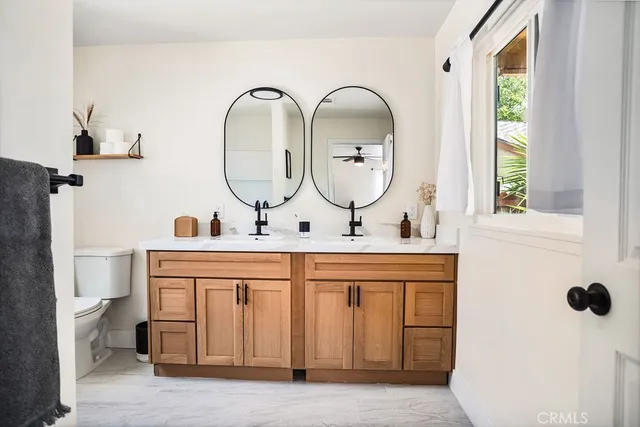 a bathroom with a double vanity sink and a mirror