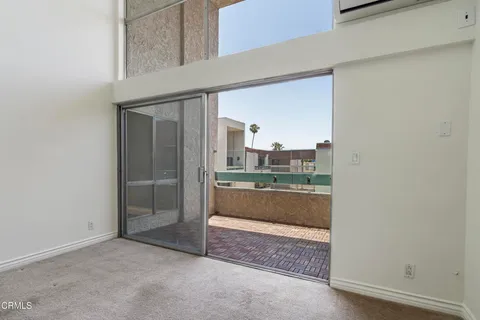 a view of a wooden door and a living room