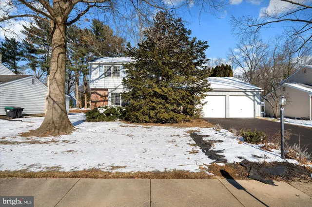 a view of a yard covered with snow in front of house