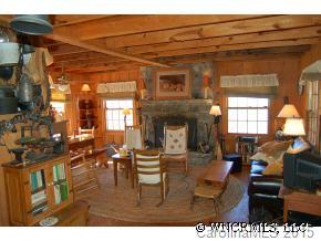 789 Doc Graham Road Clyde, NC 28721 - Photo 4 of 12 a living room with furniture a fireplace and a flat screen tv