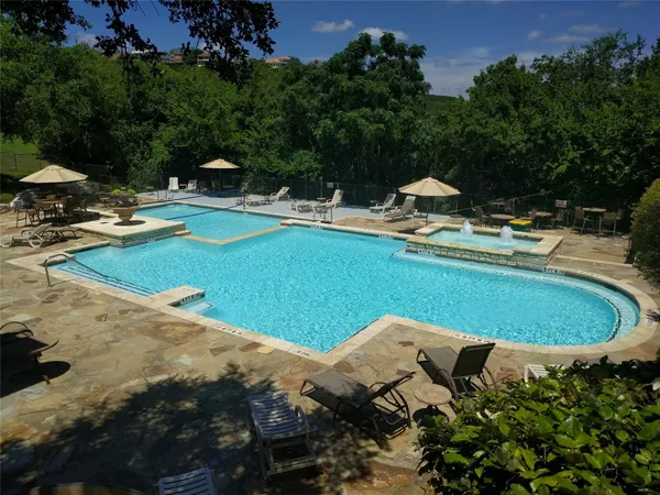 a view of a swimming pool and lounge chairs