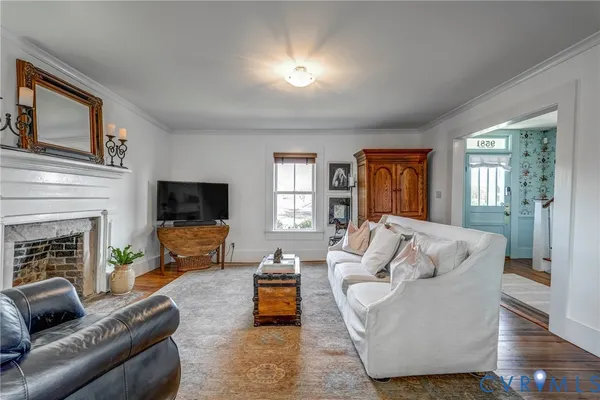 a living room with furniture a fireplace and a flat screen tv