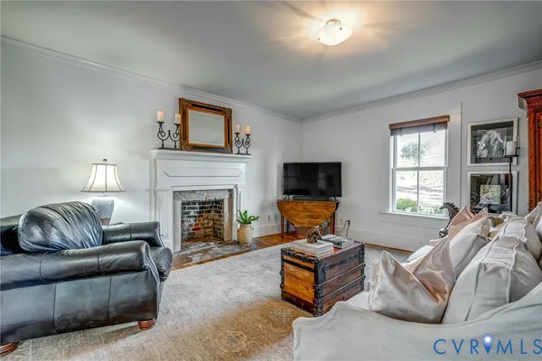 a living room with furniture a couch and a potted plant