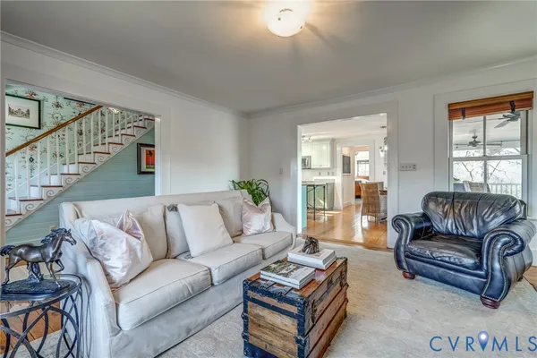 a living room with wooden floor and furniture