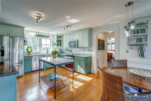 a kitchen with stainless steel appliances granite countertop a refrigerator and a stove top oven