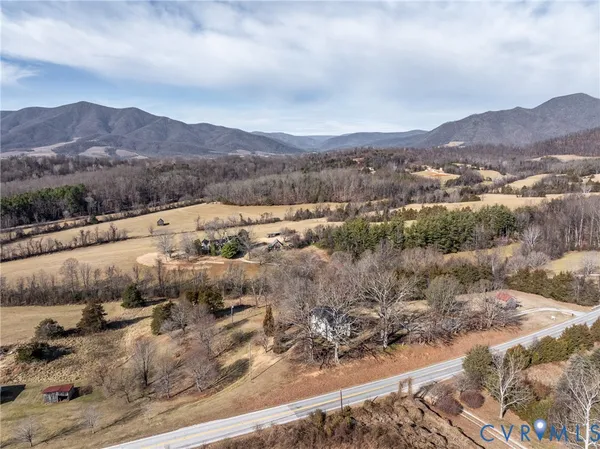 an aerial view of houses covered in trees