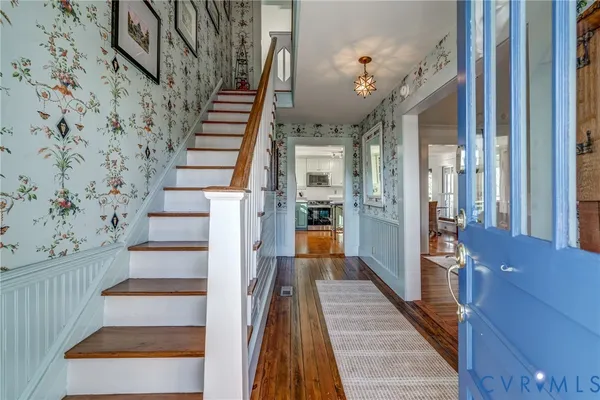 a view of entryway and hall with wooden floor