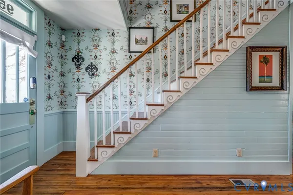 a view of entryway and hall with wooden floor