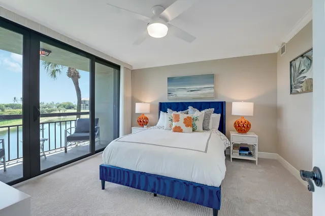 a bedroom with a bed and large window