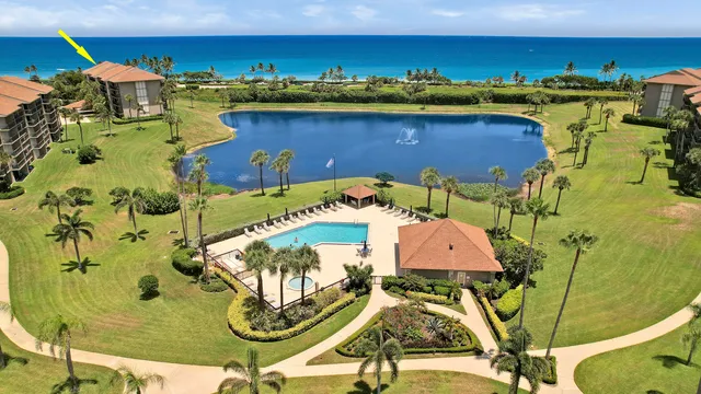 an aerial view of a swimming pool with outdoor seating