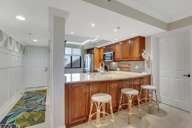 a large kitchen with a table and chairs in it