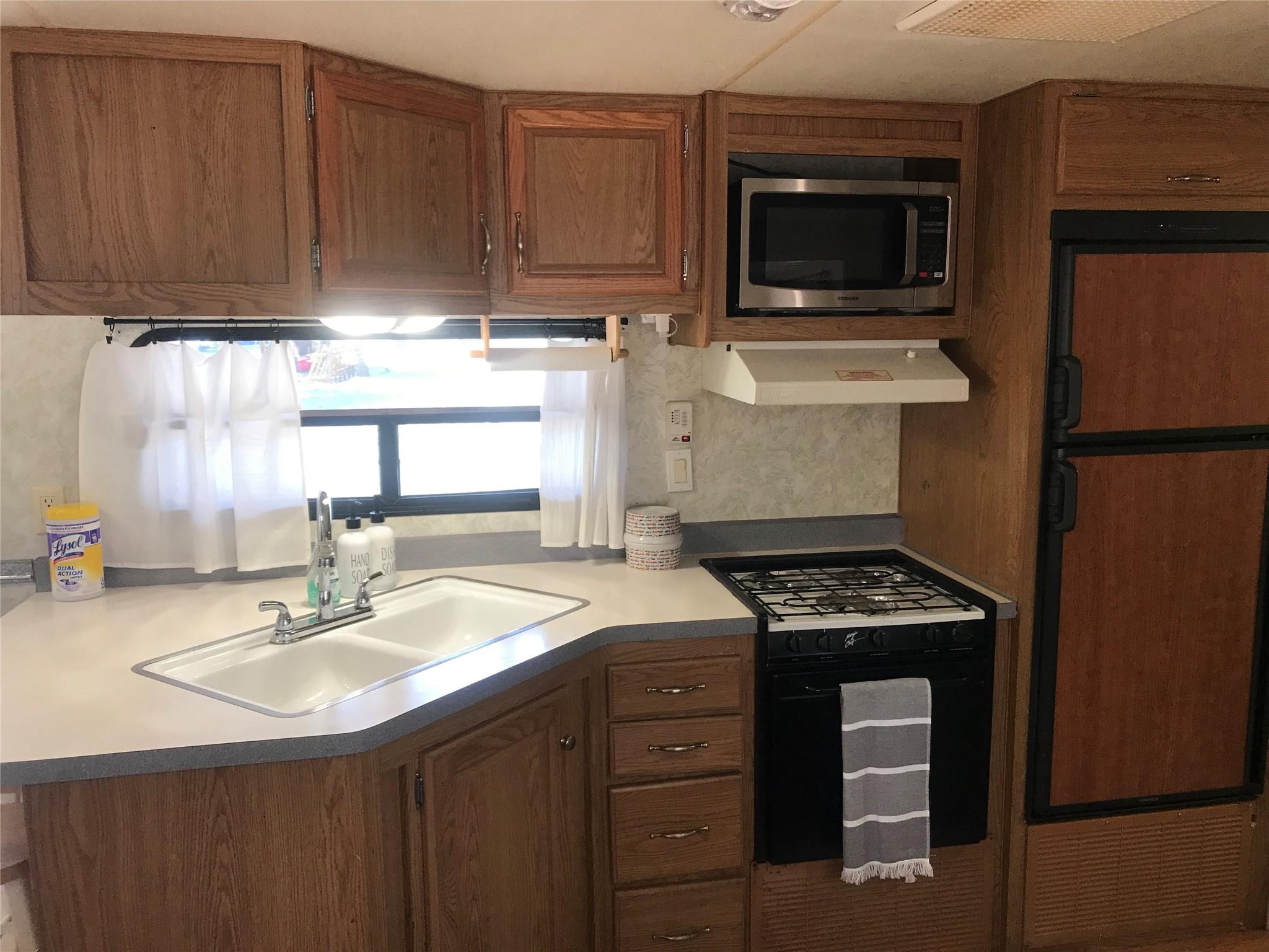 150 Roberts Ridge Road, Unit H48 Mount Gilead, NC 27306 - Photo 17 of 35 a kitchen with a sink stove and microwave