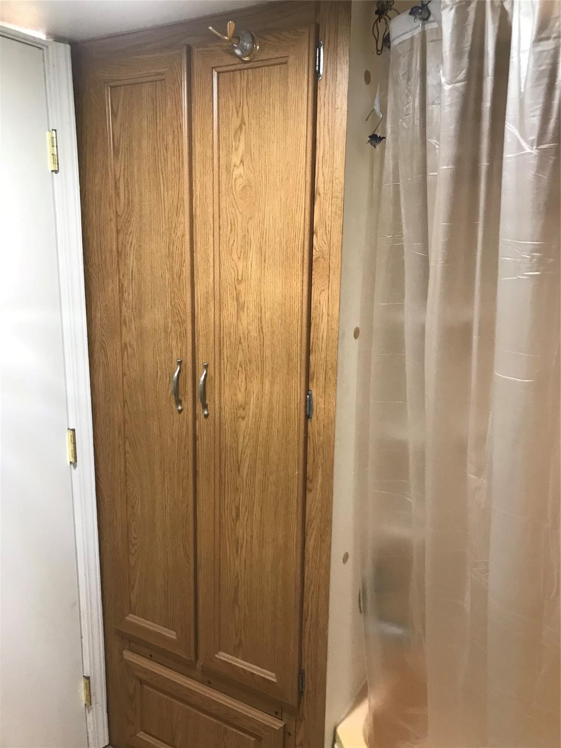 150 Roberts Ridge Road, Unit H48 Mount Gilead, NC 27306 - Photo 28 of 35 a bathroom with a shower and wooden door