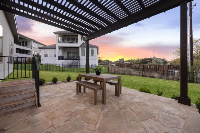a view of a patio with a table chairs and a backyard