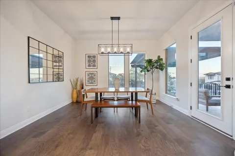 a large kitchen with stainless steel appliances lots of counter space and wooden floor