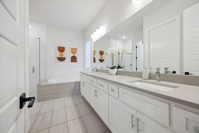 a spacious bathroom with a sink mirror and shower