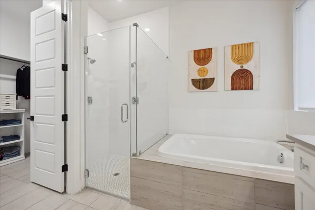 a bathroom with a tub and a shower
