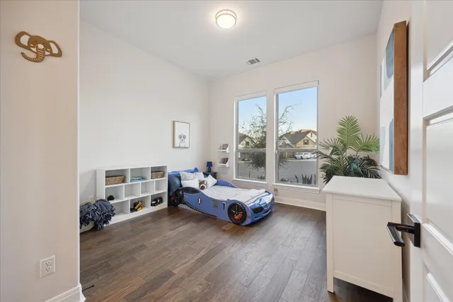 a bedroom with furniture and a large window