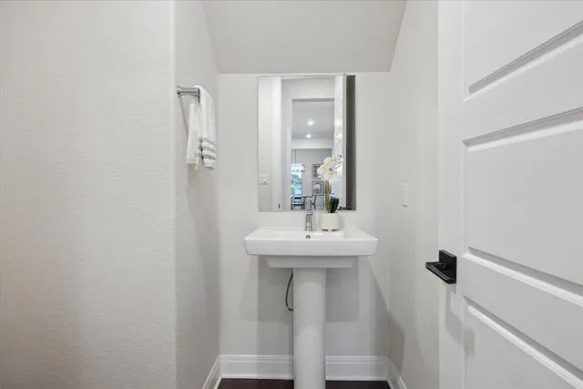 a bathroom with a sink a mirror and a toilet