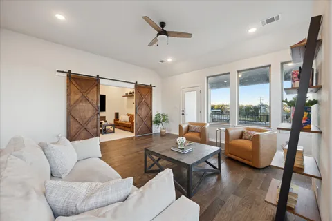 a view of a balcony with furniture and a floor to ceiling window