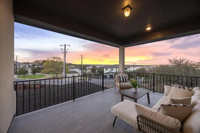 a view of a balcony with furniture and a floor to ceiling window