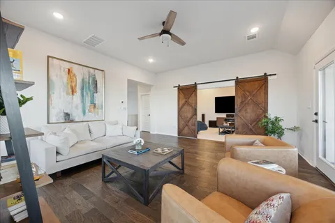 a living room with furniture and wooden floor