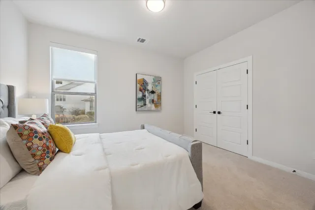 a bedroom with a bed and a window