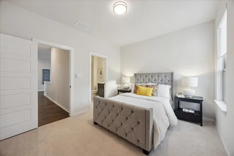 a bedroom with a bed and a lamp